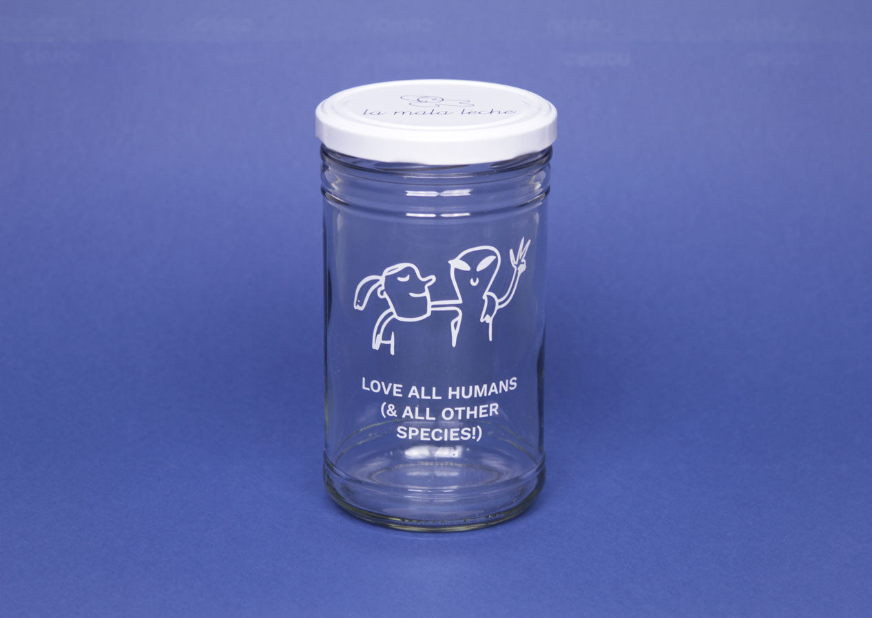 Beautiful glass jar with an illustration and the text "love all humans and all other species"
