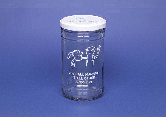 Beautiful glass jar with an illustration and the text "love all humans and all other species"