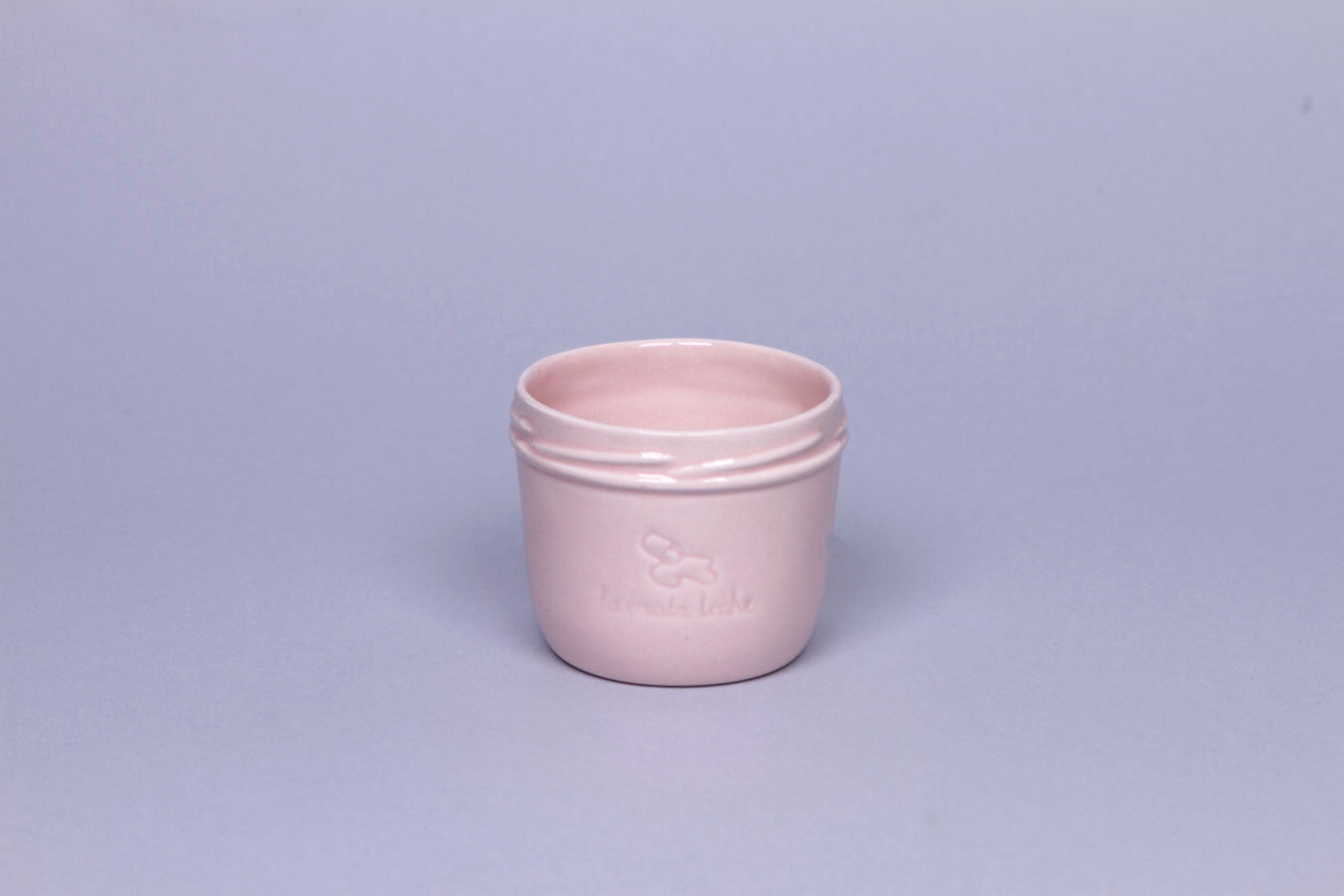 Delicate ceramic cup in light pink color.