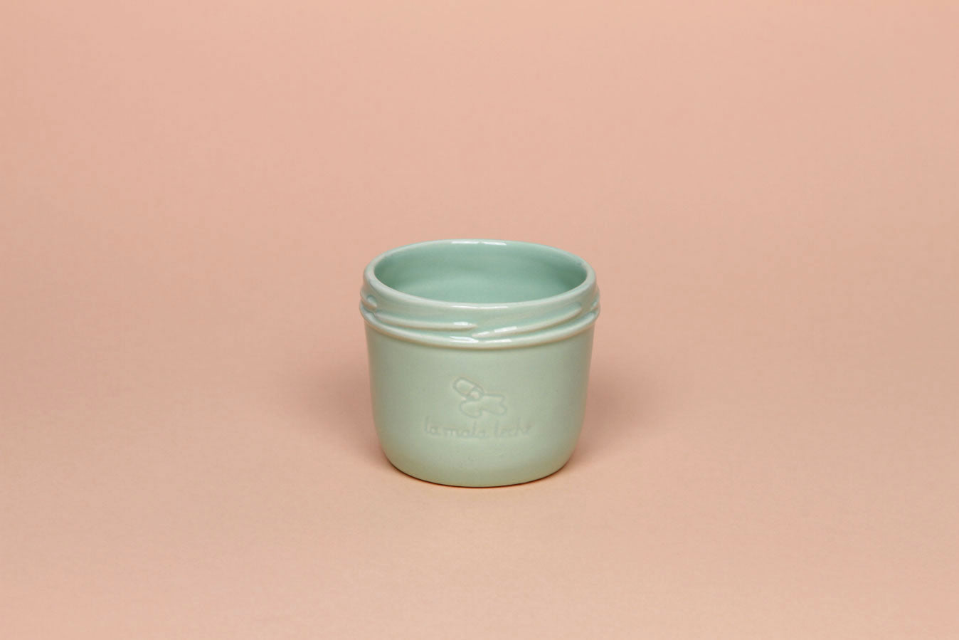 Delicate ceramic cup in turquoise color.