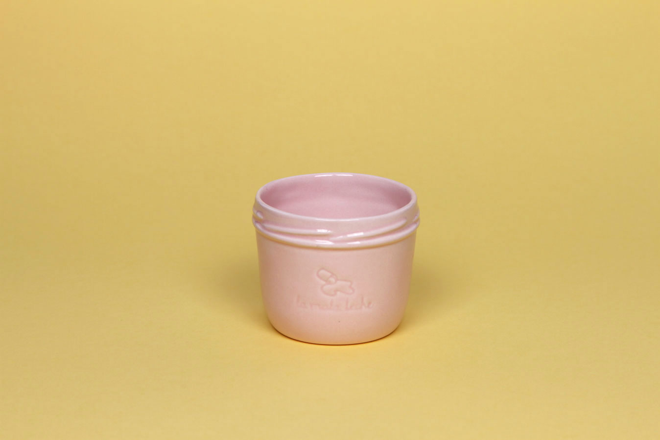 Delicate ceramic cup in light pink color.